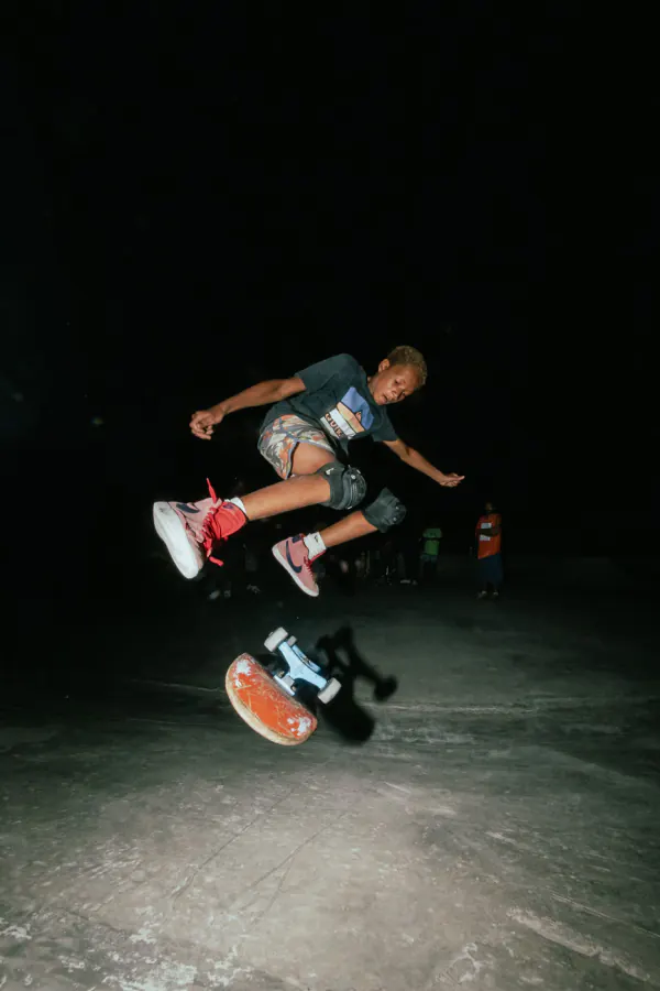 Close-up of a skater kickflipping with pink shoes
